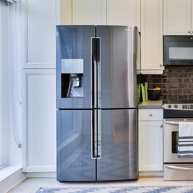 A stainless steel refrigerator with an ice maker