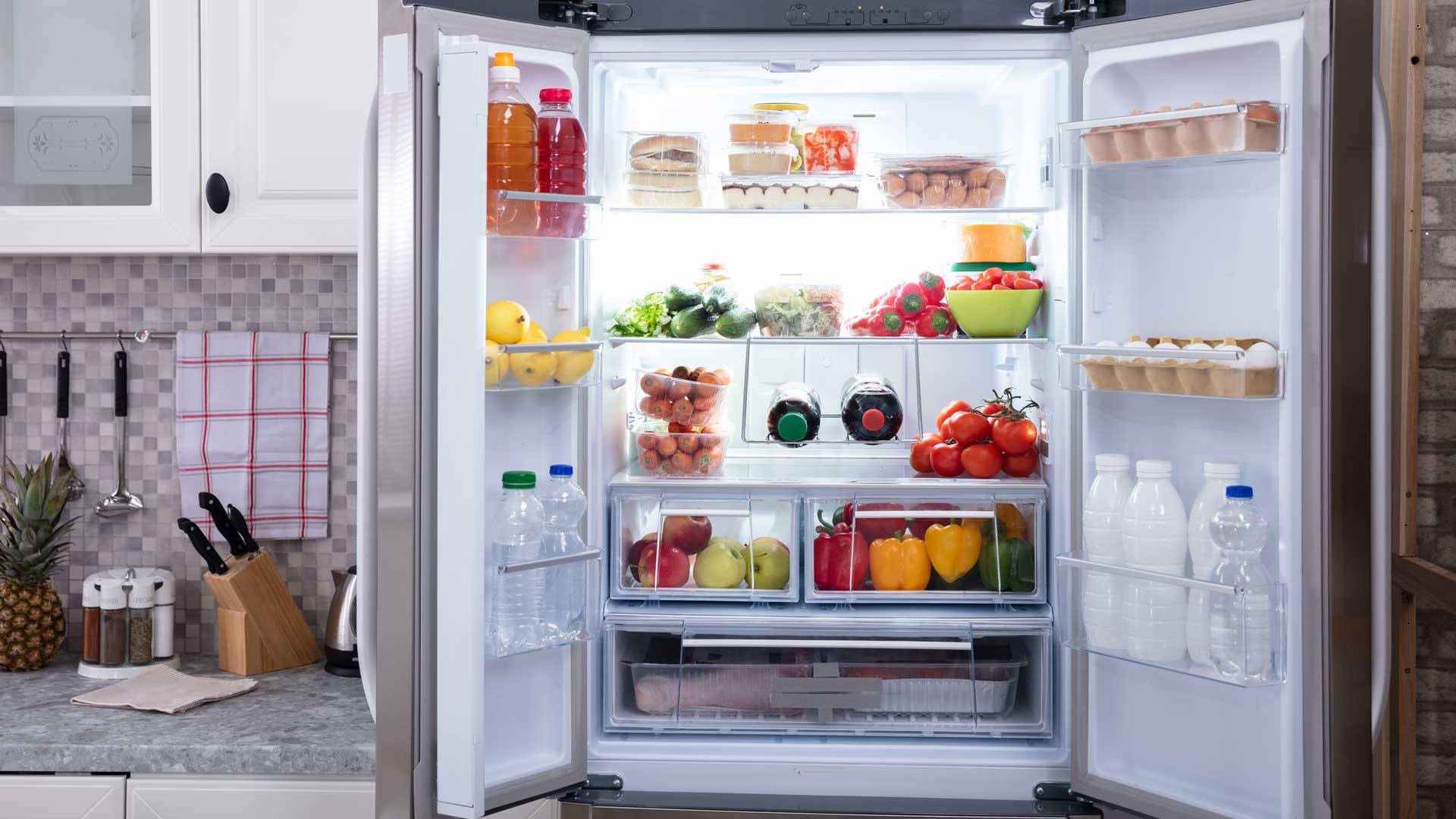 An open, well-stocked refrigerator
