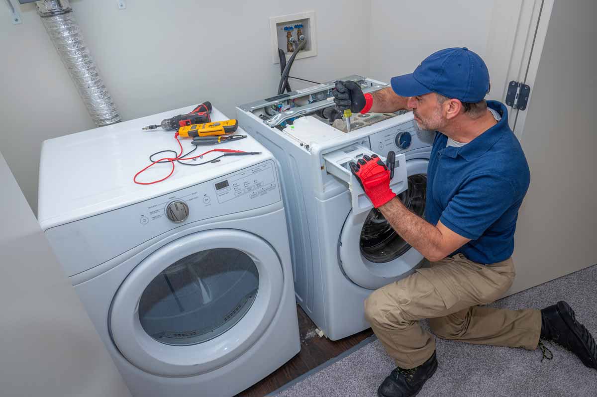 A technician repairing a washing machine
